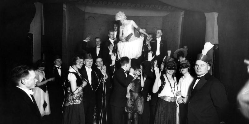 Black and white photo of party in fancy dress.